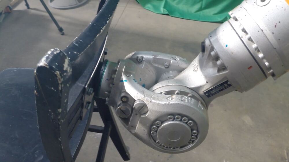 Close up of the arm's wrist bolted to the back of the chair