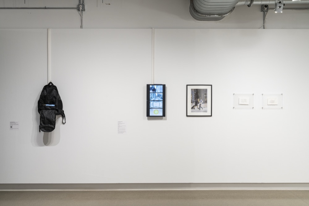The backpack hanging on the gallery wall
