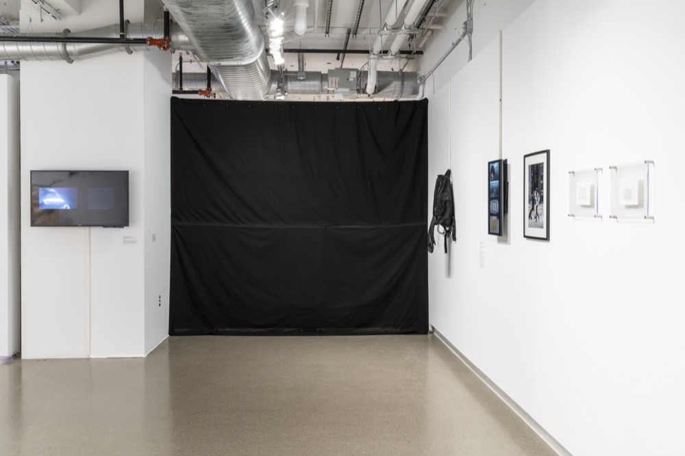 The curtain in the gallery, between the TV and the right wall