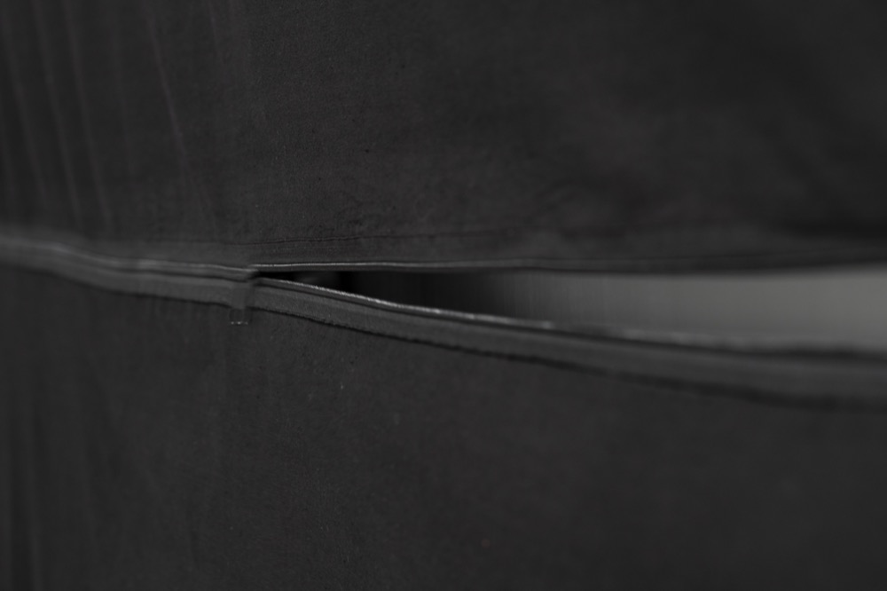 The curtain's zipper, partly open